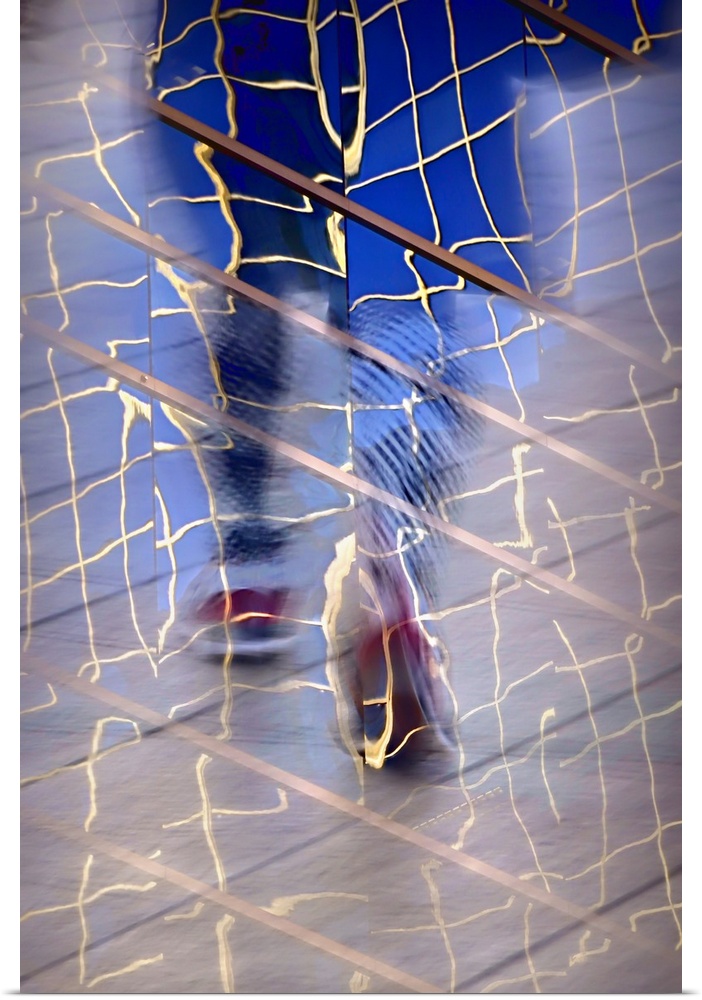 Abstract image created by a reflection of a person walking in building windows.