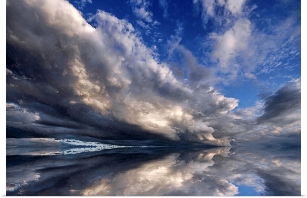 Photograph of cloudy sky that is reflected in the ocean below.