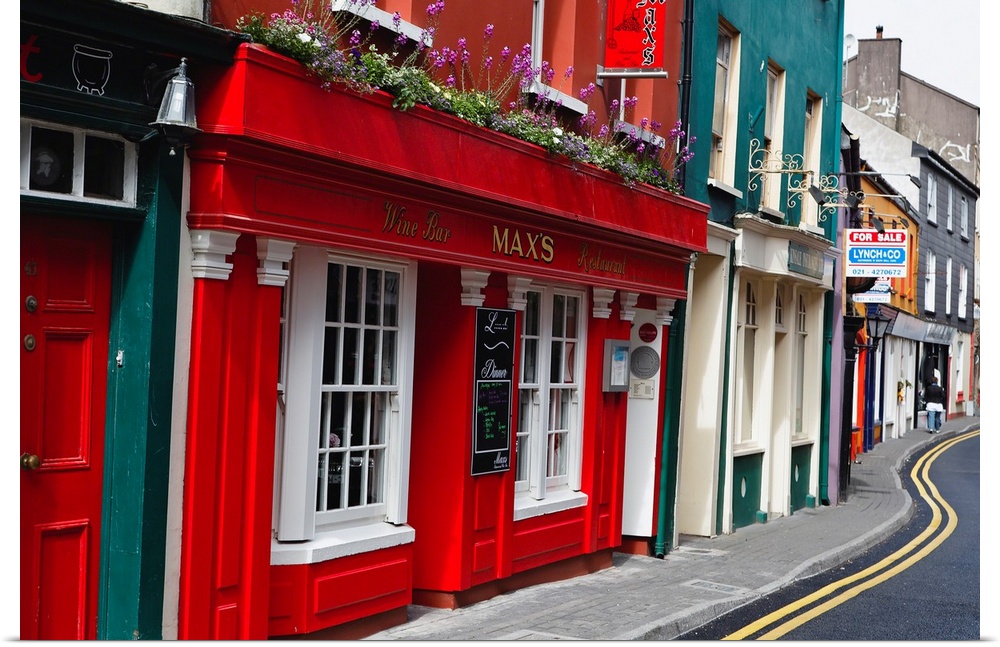 Colorful buildings in Ireland line a winding street.