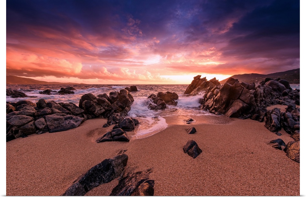 A photograph of a rocky sunset coastal landscape.