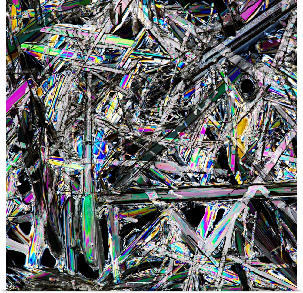 Close-up photograph of a white crystals with spectrum's of color in the facets.