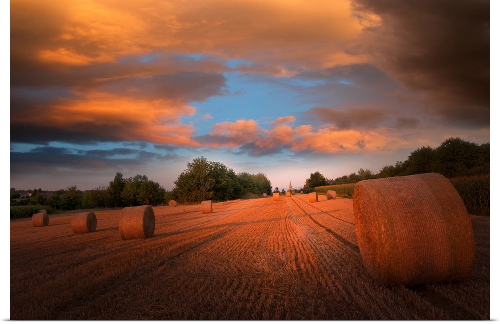 Sunset over bales of hay