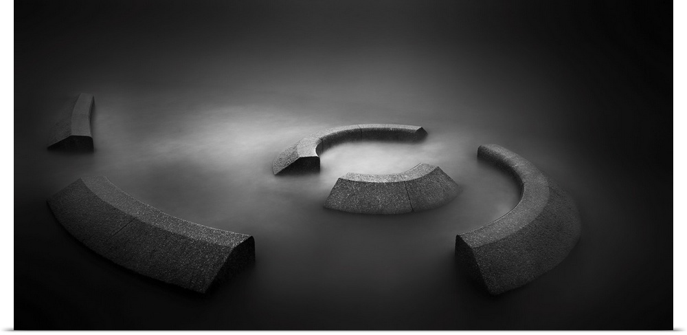 A contemporary dramatic monochrome black and white intense image of a spiral concrete installation with glowing still wate...