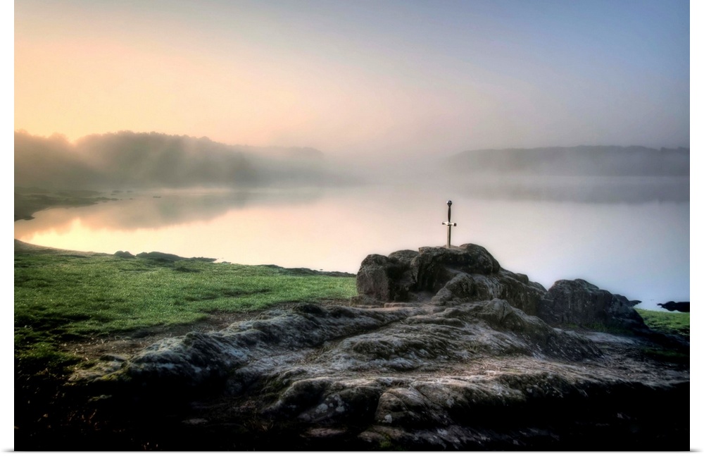 Excalibur legendary sword blocked inside a rock with a lake and fog behind in Broceliande forest in France, Brittany area.