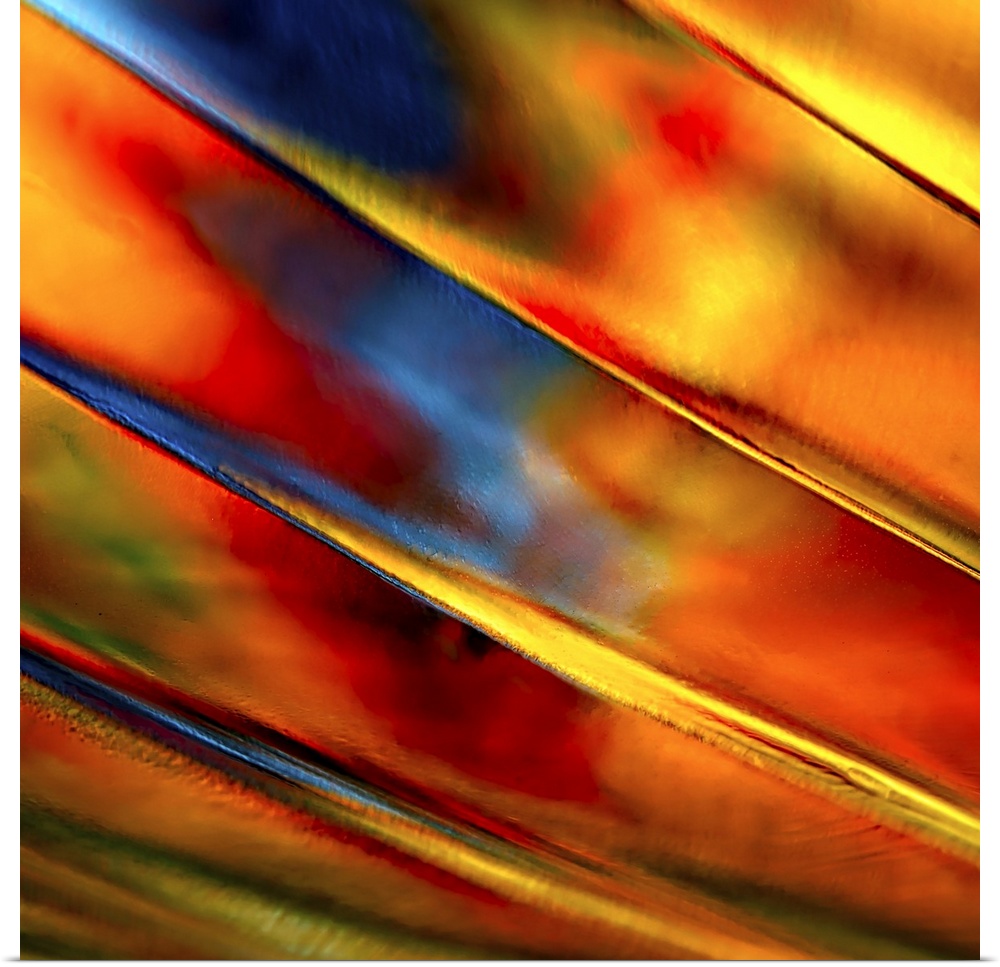 Abstract photograph of orange ridges against red and blue.