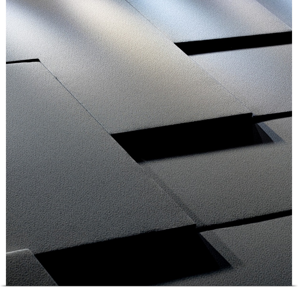 A contemplative photograph where a detail of architecture forms an abstract geometric image of blacks, whites, grays and s...