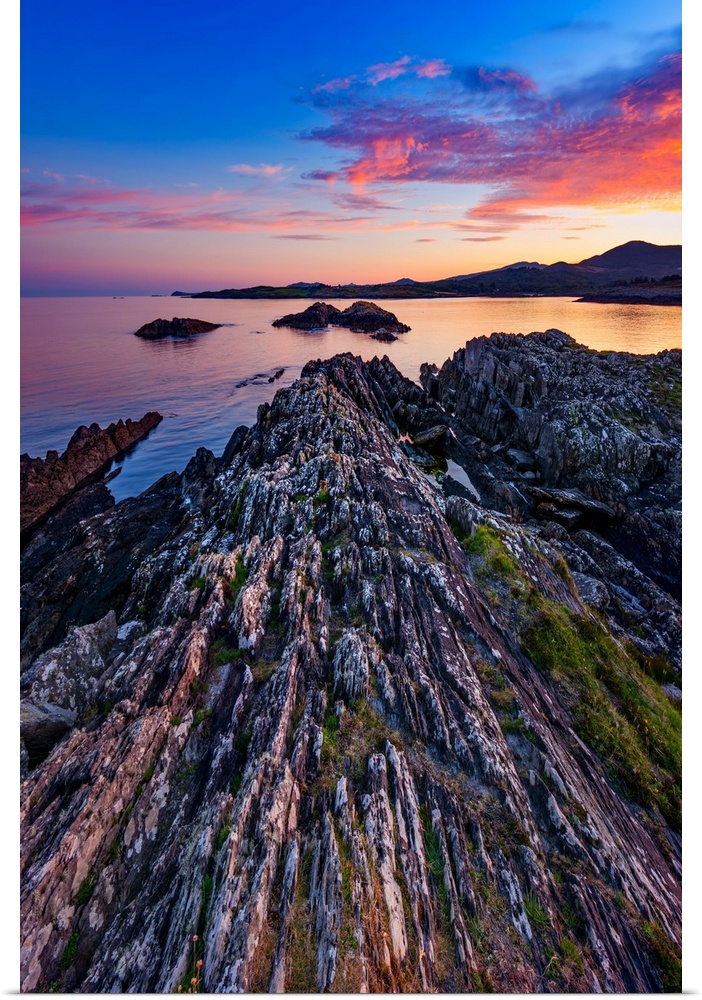 Sunset over the sea in Ireland with rocks in the foreground
