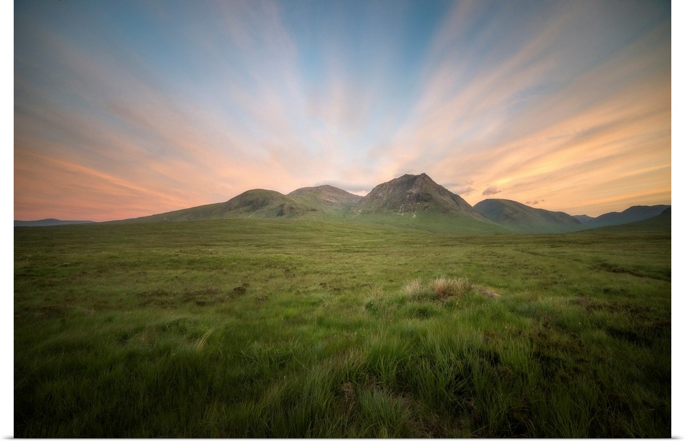 Glencoe valley at sunset next to etive mor in scotland, a green valley with mountains on background.