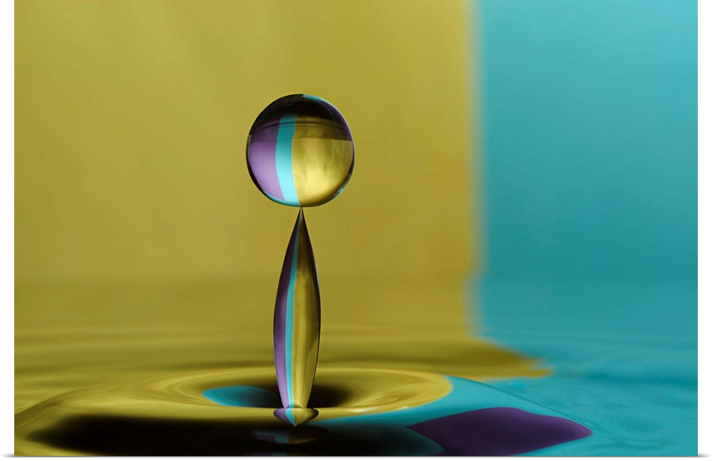 A macro photograph of a water droplet sitting suspended in air against an abstract background.