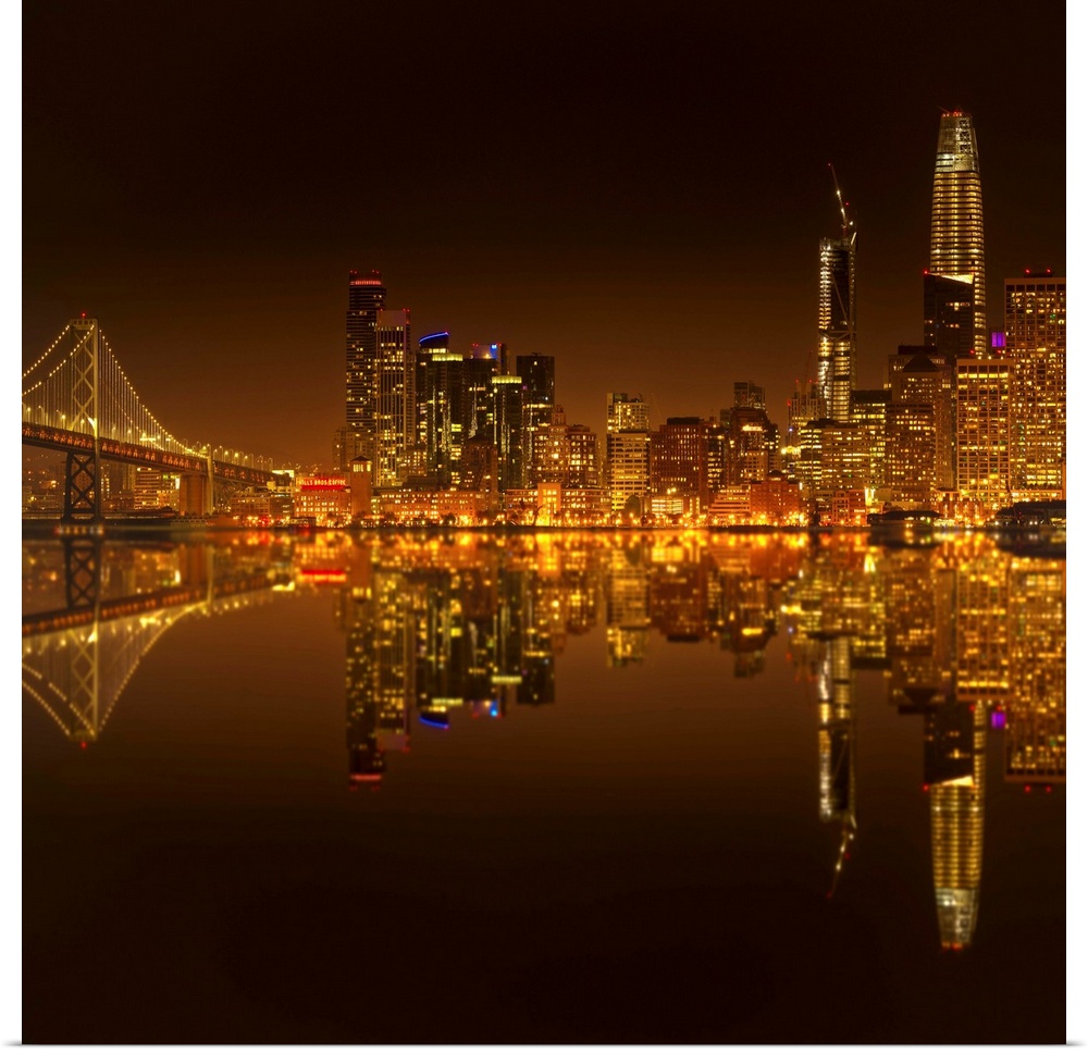 Photograph of the city skyline of San Francisco reflecting in the Bay at night.