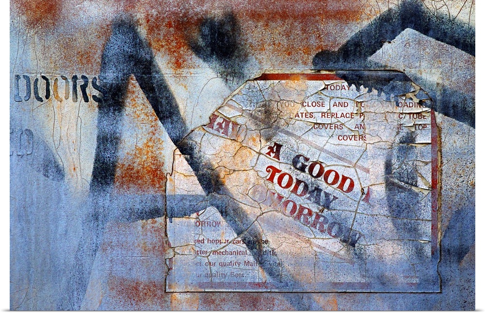 A photo of a rusted metal door with a faded sign and graffiti.
