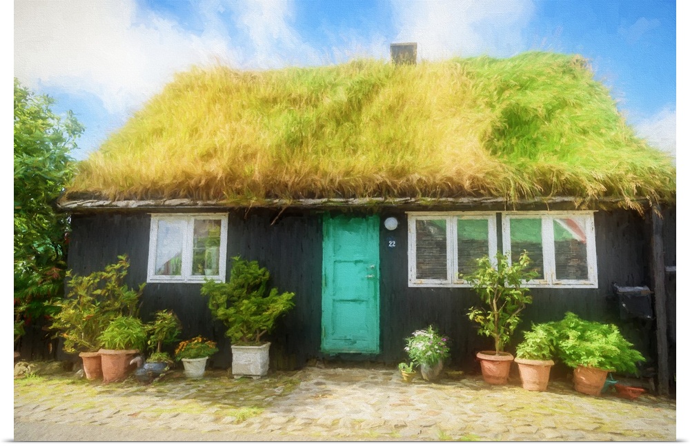A black house with a turquoise door with a grassy roof.