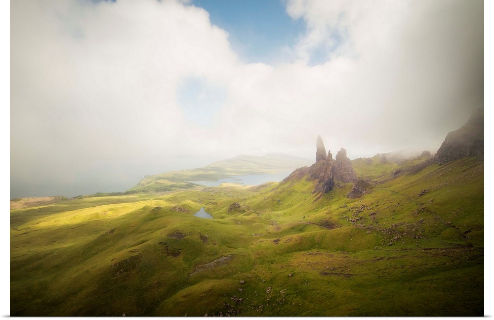 Old Man of Storr peaks moutains on  Trotternish Peninsula, Isle of Skye, Scotland, with clouds shadows on the green valley