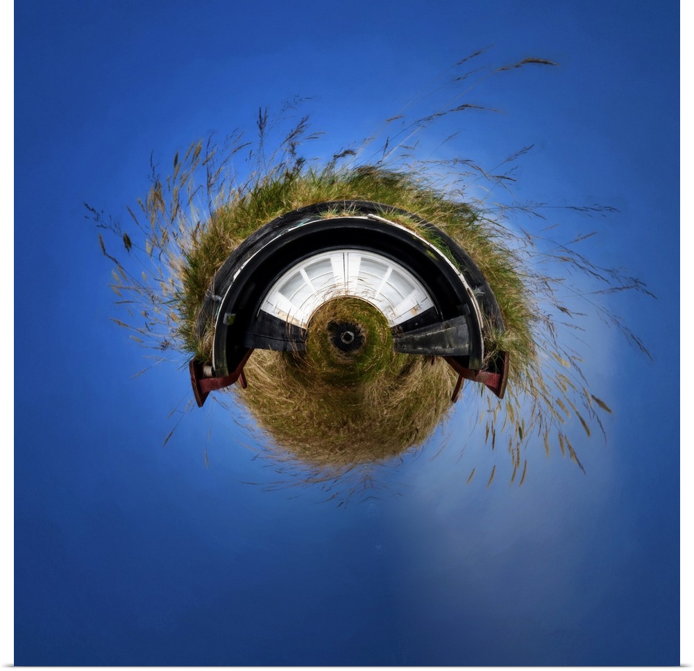 Tall grass growing on the roof of a small house against a deep blue sky, with a stereographic projection effect on the ima...