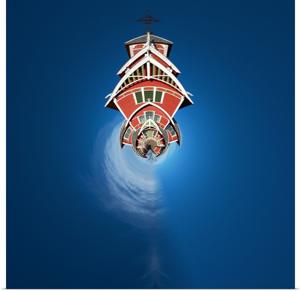 A large red barn against a deep blue sky, with a stereographic projection effect on the image, resembling a tiny planet.