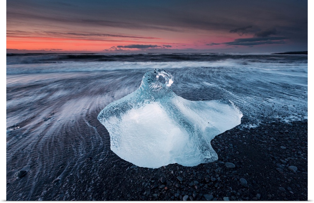 One of the many icebergs on the beach near Jokulsarlon, Iceland, captured during sunrise.