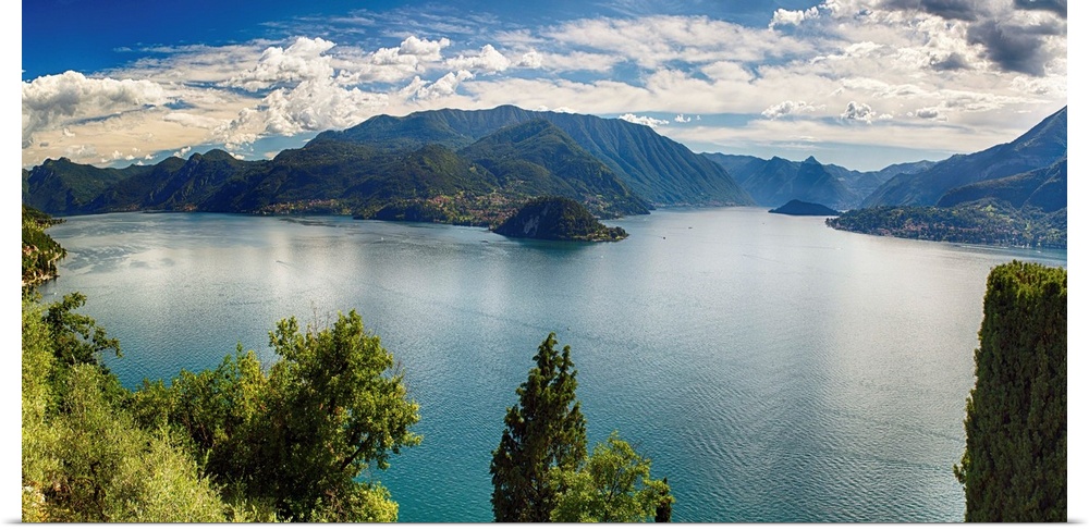 Fine art photo of Lake Como in Italy with mountains in the distance under a cloudy sky.