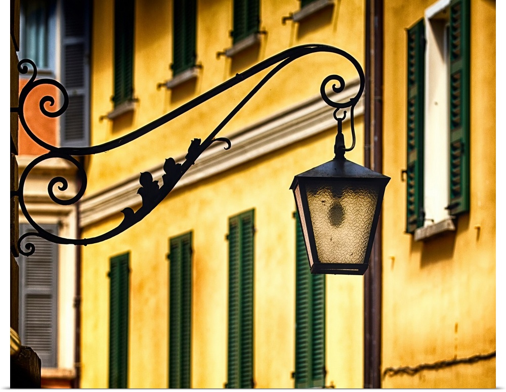 Fine art photo of a lantern on an iron hanger in an Italian city.