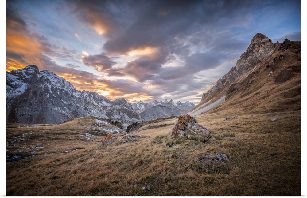 Fine art photograph of an alpine landscape with colorful clouds overhead.