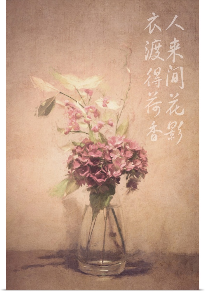 Asian calligraphy on a wall beside dusty pink and white flowers in a clear glass vase.