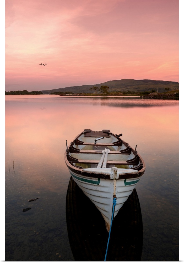 A fishing boat on a lake in Ireland at sunset