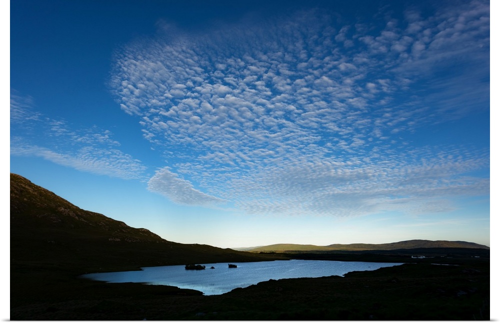 Cloudy blue sky over a lake in Ireland