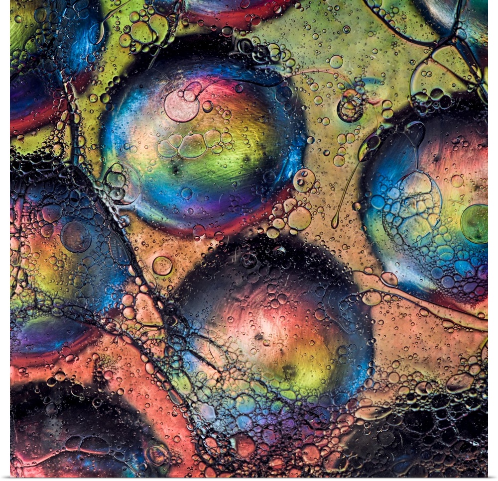 An abstract fine art photo of several bubbles with rainbow colors.
