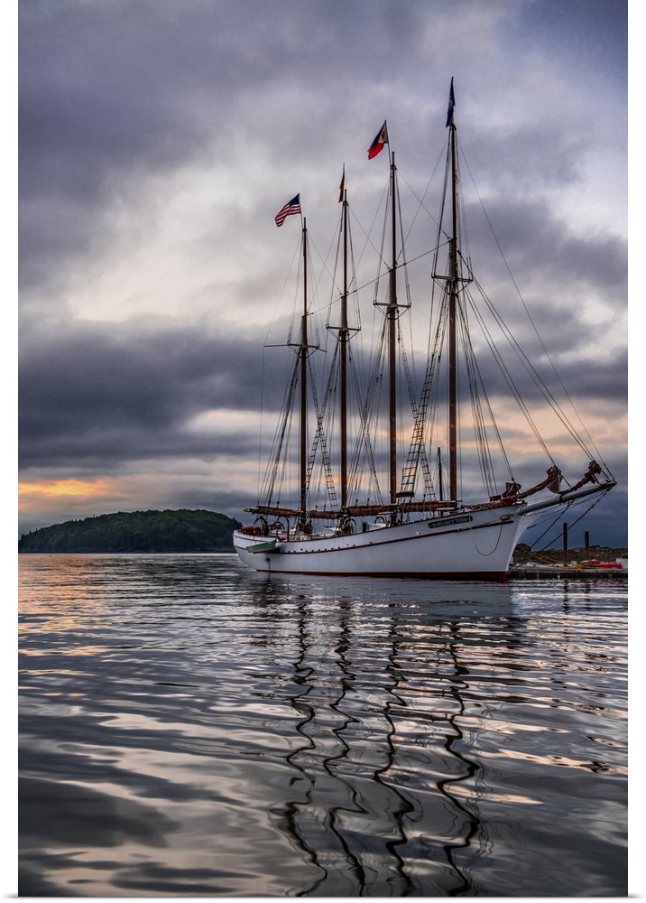 Beautiful sailing ship Margaret Todd rests at it's pier amidst a dramatic atmospheric sunrise in Bar Harbor Maine.
