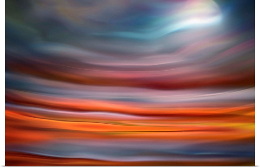 Abstract photo of smooth waves in warm colors, resembling the moon rising over the ocean.