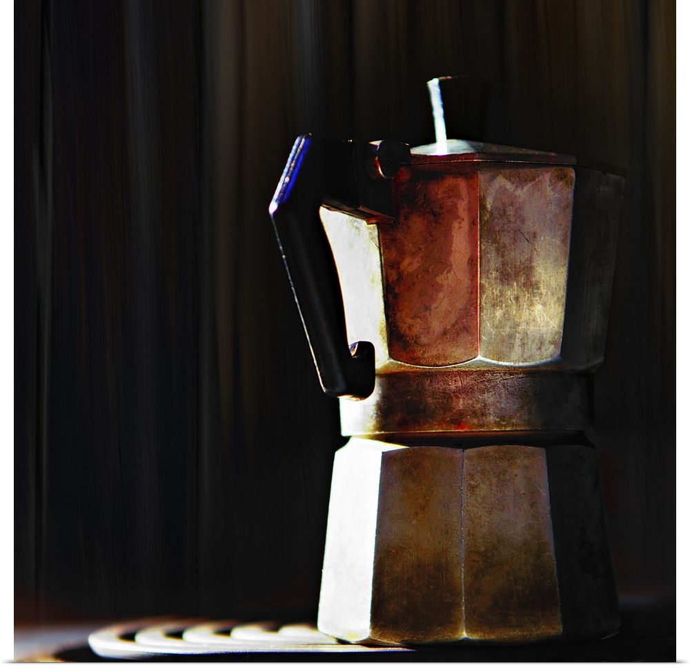 A metal coffee pot in the sunlight.