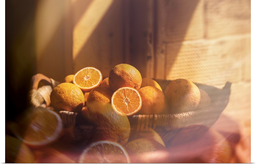 Composited photograph of a woven basket filled with oranges in the morning sunlight.