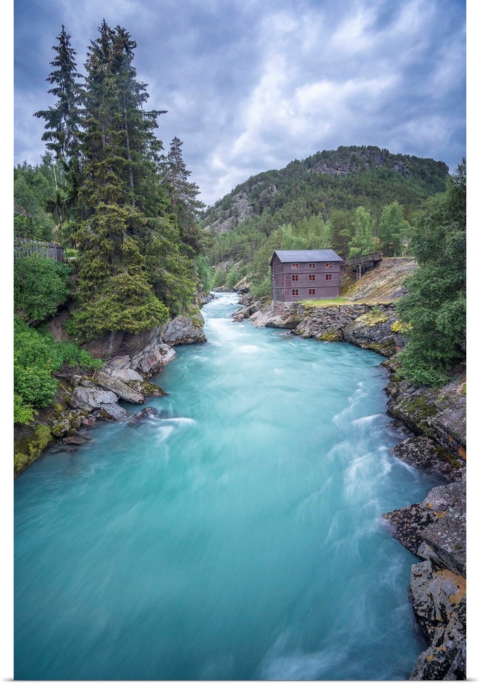 A photograph of a crystal blue river flowing through a Norwegian landscape.