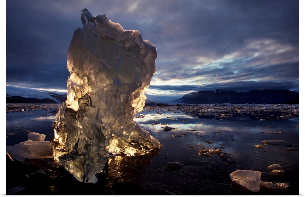 A chunk of an iceberg glows with sunlight coming through it, Alaska
