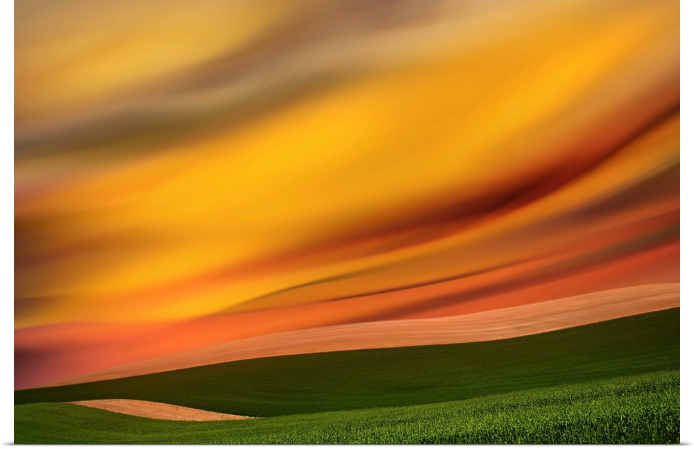 Abstract photograph of the Palouse farmland in Washington state, with a vibrant golden yellow motion blurred sky.