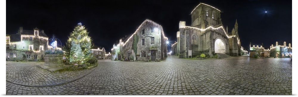 Panoramic view of a historic village at night.