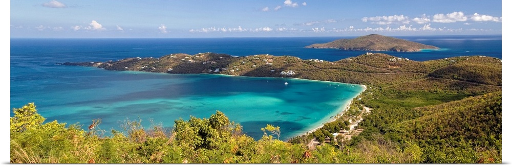 This panoramic photograph is an aerial shot of a bay in the virgin islands surrounded by large hills.