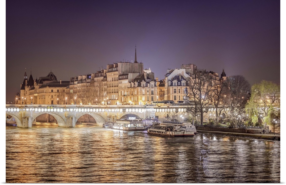 A photograph of Paris from the Seine river at night.