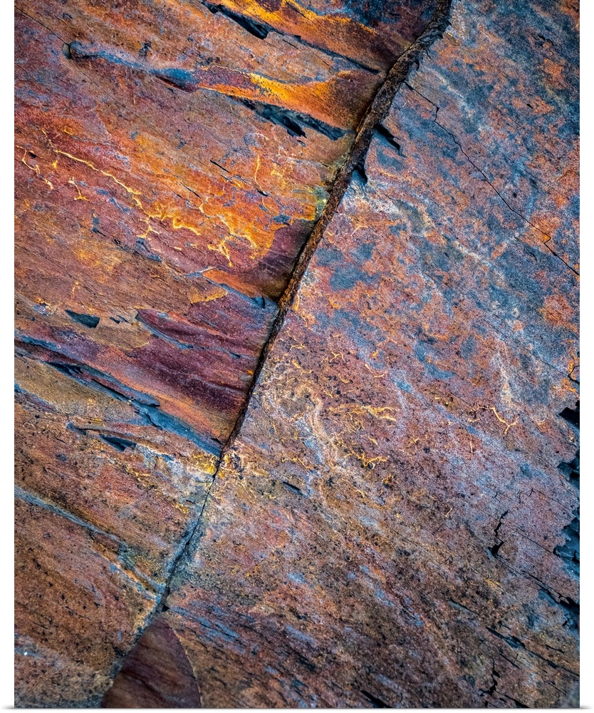 A contemporary natural abstract of patterns in rock in rich pinks, oranges, blues, golds and purples.
