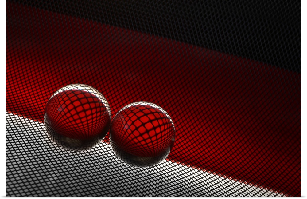 Two glass spheres reflecting a field of small dots against red.