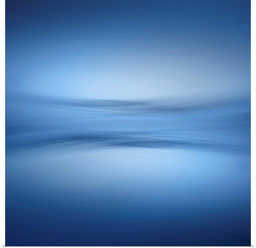 Abstract photograph of a faint horizon line separating a peaceful blue lake and a clear sky.