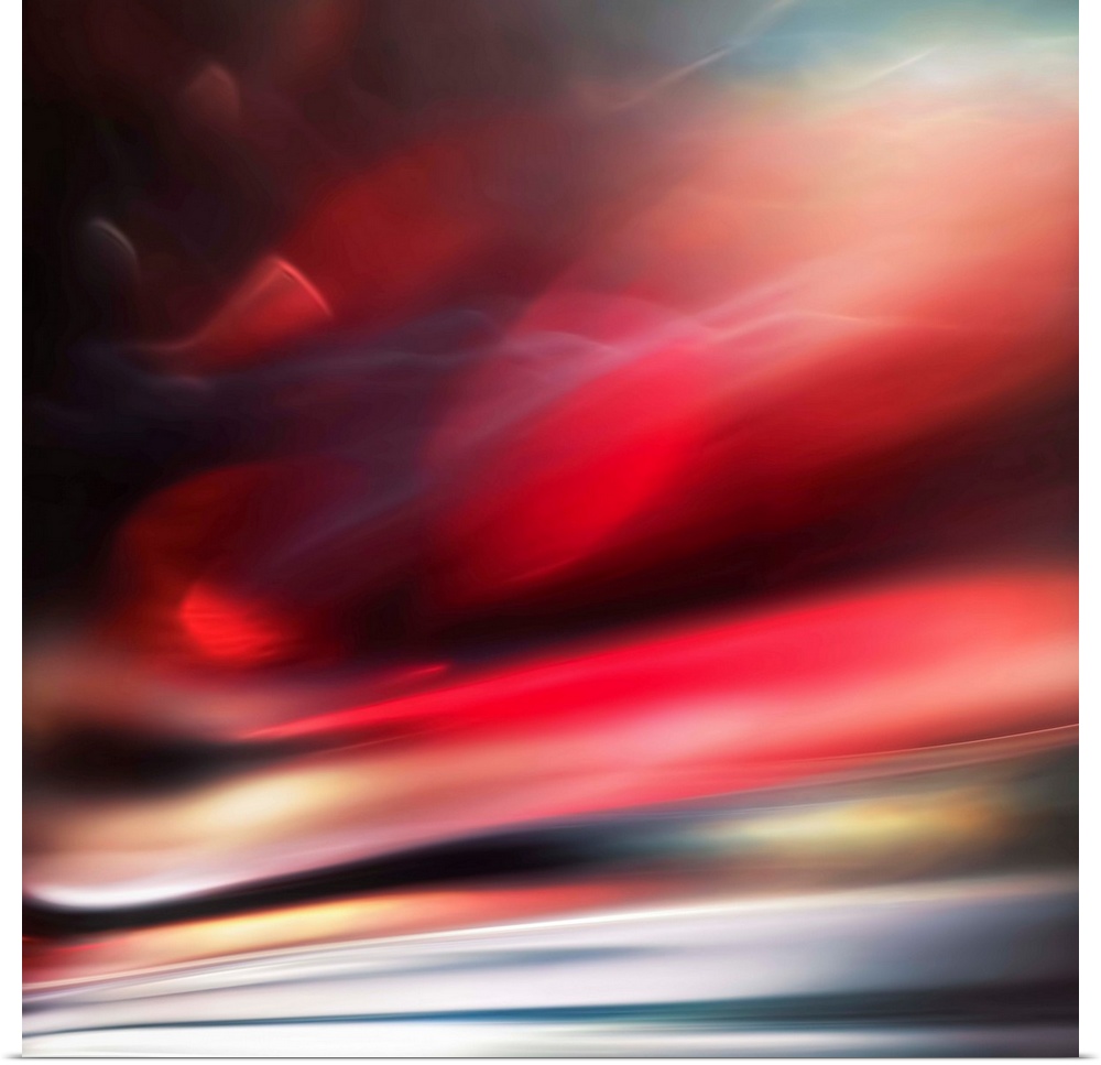 Abstract photograph of a vibrant red motion blurred color field.