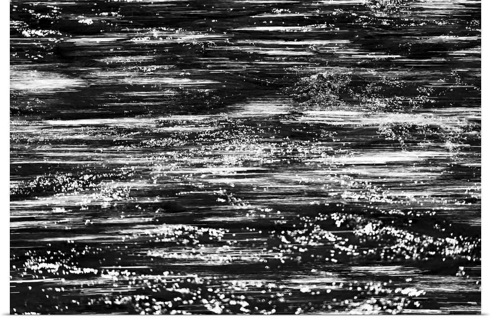 Black and white abstract image of rushing water in a river.