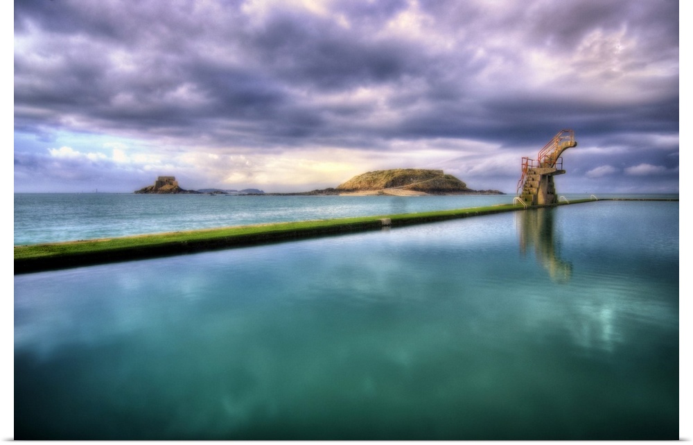 Saint Malo in Brittany, France, the natural sea water pool called Piscine de Bon Secours, with clouds and sea.