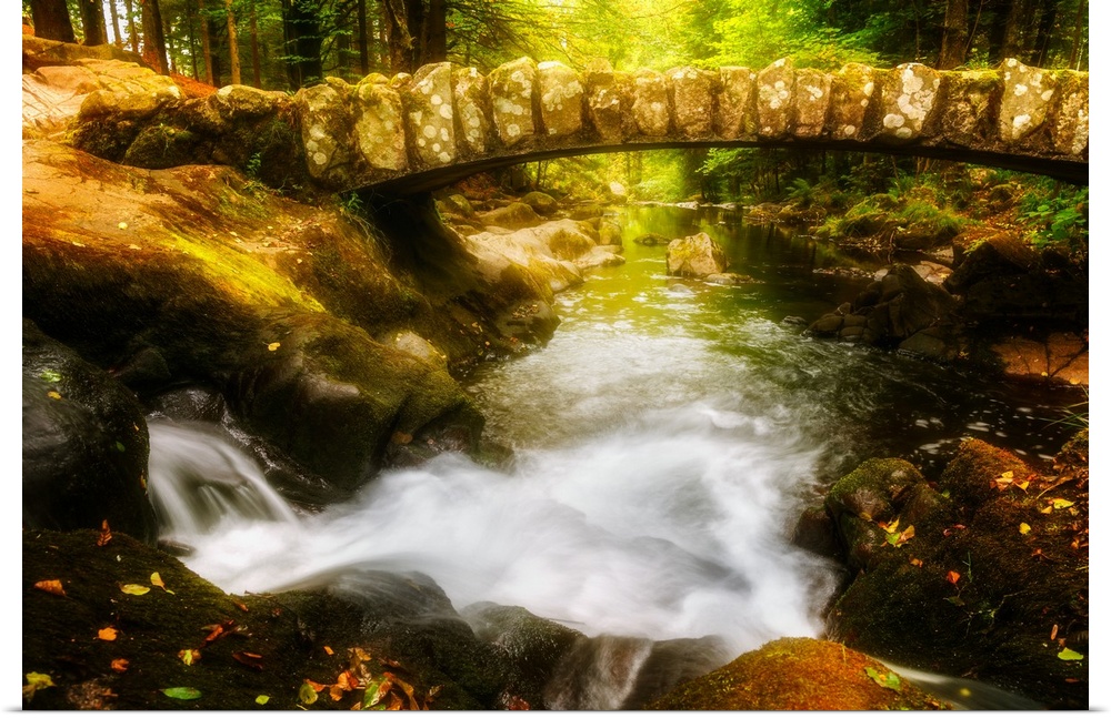 Old stone bridge over the Saut des Cuves (Waterfall of the Holes) in the forest near Gerardmer, France.