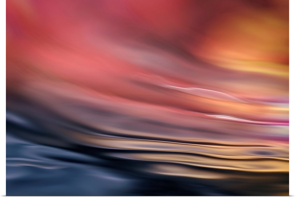 Abstract photograph of softly rippling water in red and orange tones.