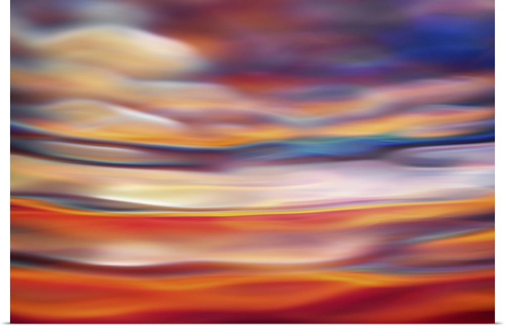 Abstract photograph in orange and red shades resembling ocean waves.