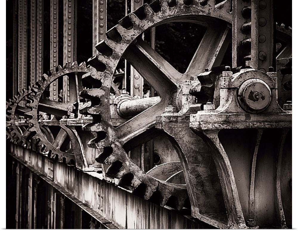 A photograph of a set of large old looking gears that operate a gate.