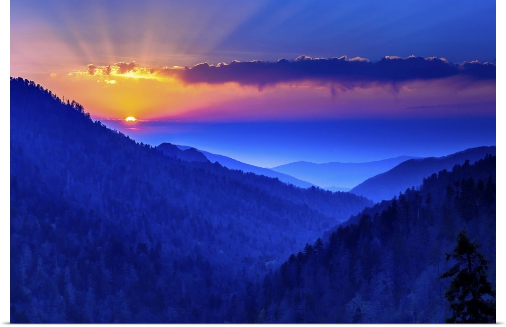 Warm rays of sunlight illuminating the deep blue sky over the Blue Ridge Mountains.