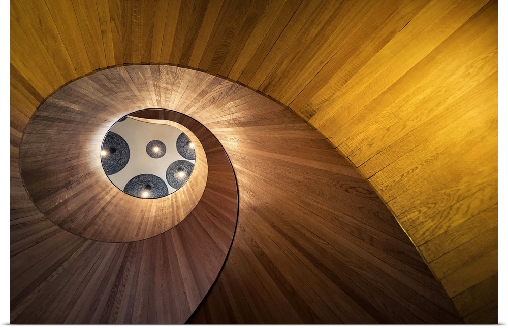 View through the center of a spiraling staircase from below.