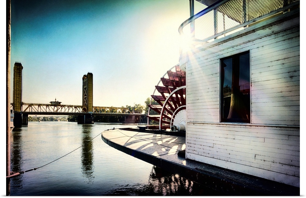 A vignette photo of a steamboat and a drawbridge.